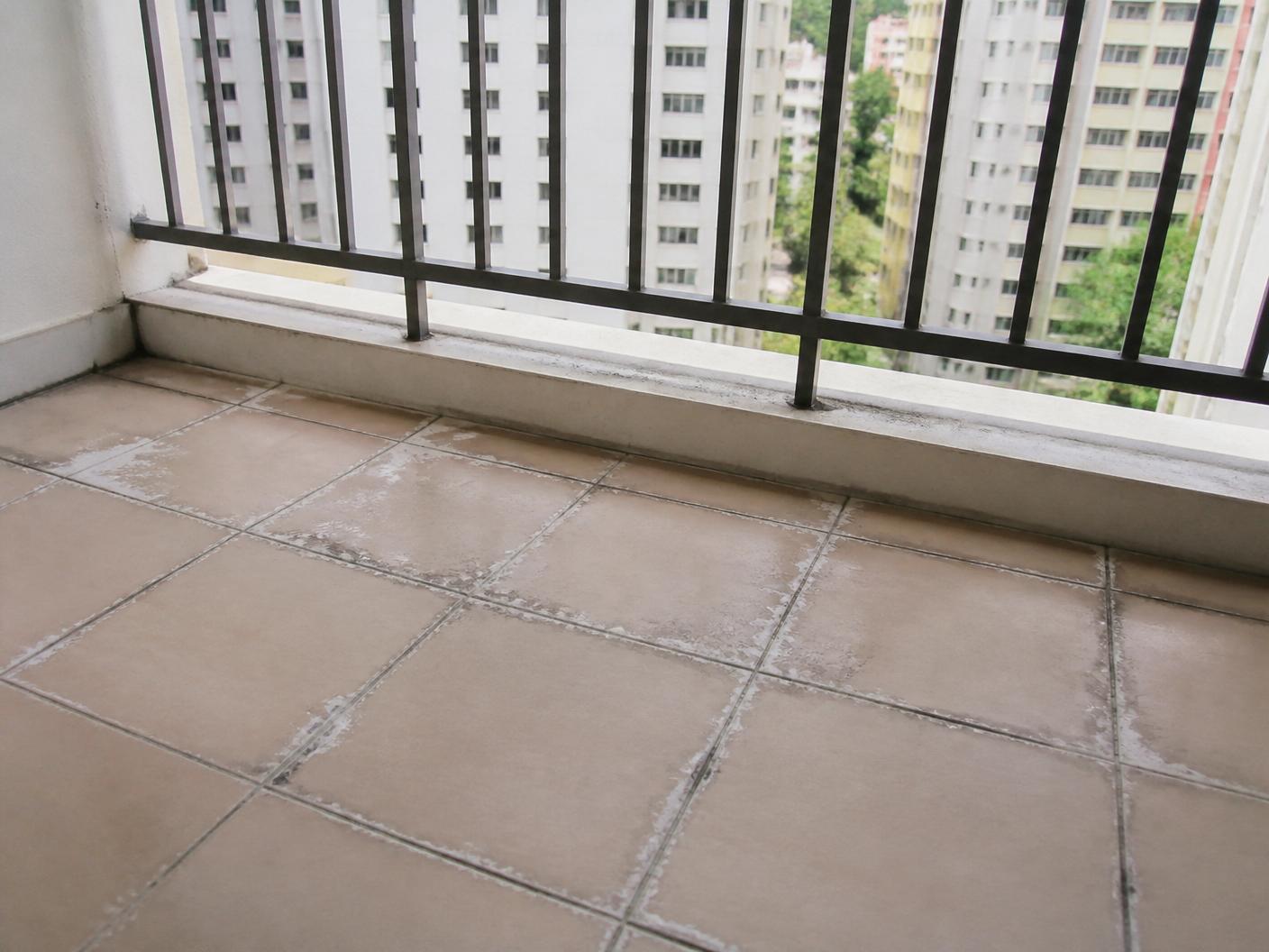 Singapore HDB balcony with cracked tile grout and water damage — before